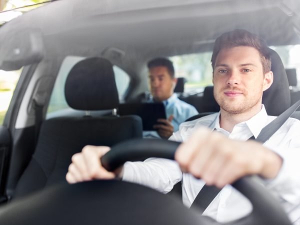 transport, vehicle and people concept - male driver driving car with passenger