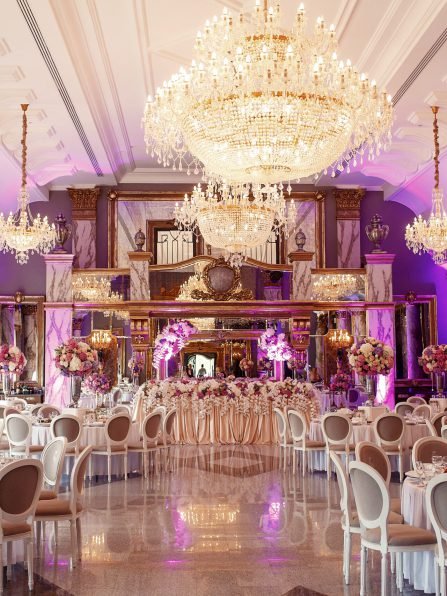 Luxurious dinner hall with large crystal chandeliers hanging from the ceiling