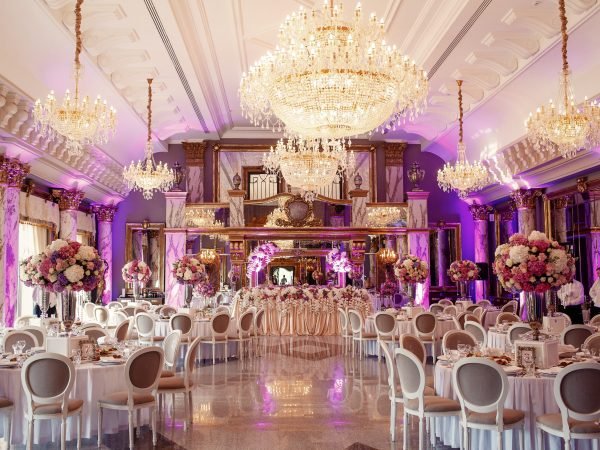 Luxurious dinner hall with large crystal chandeliers hanging from the ceiling
